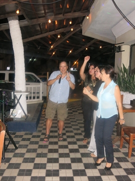 A fan club member raising a toast at a local show venue